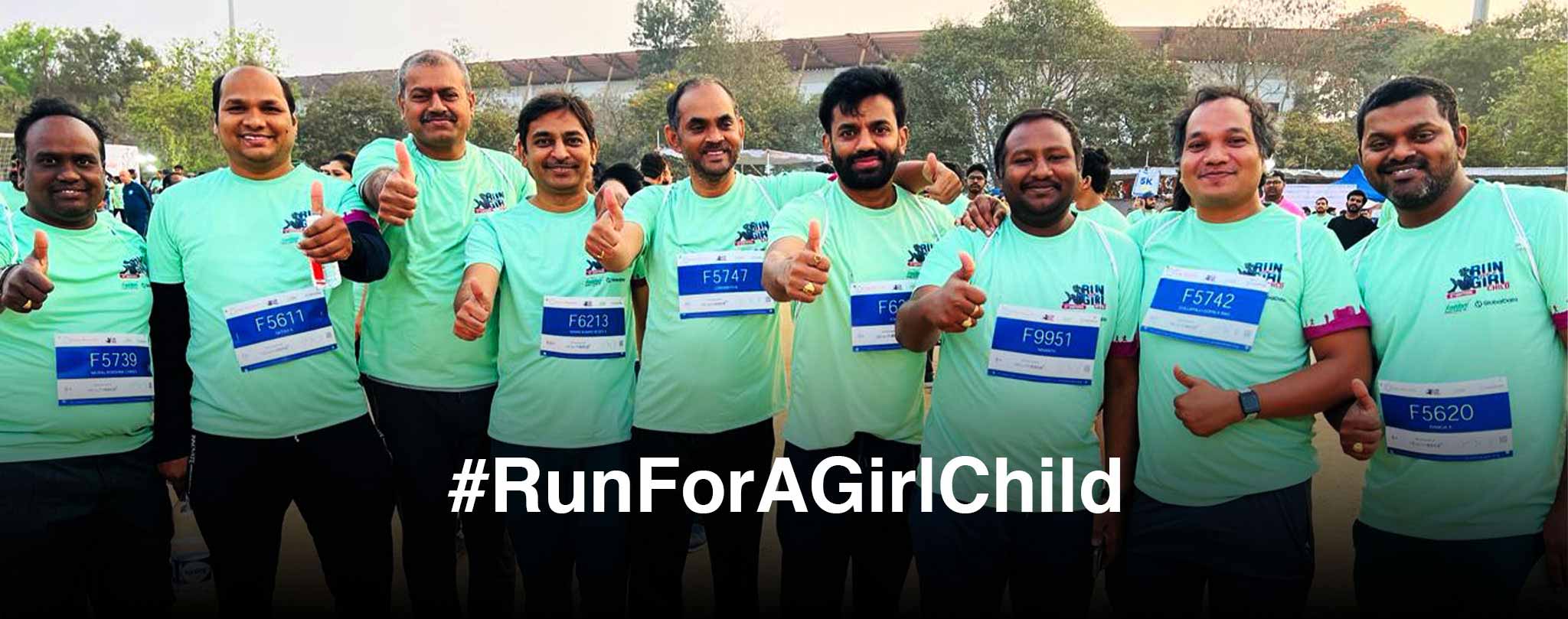 Vertex team celebrating completion of Run for a Girl Child marathon with hashtag RunForAGirlChild commitment to girls' education