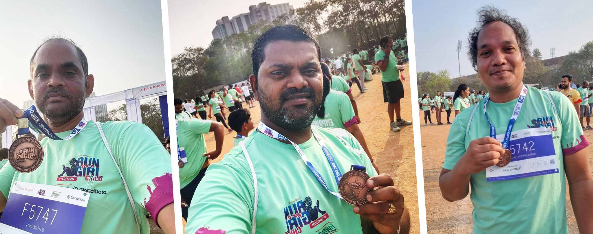 Vertex Computer Systems employees displaying Run for a Girl Child marathon completion medals at event