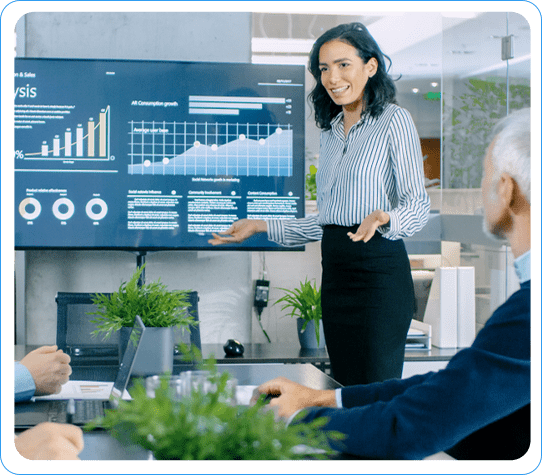 Woman presenting actionable insights with charts on a screen in a meeting with attentive colleagues.