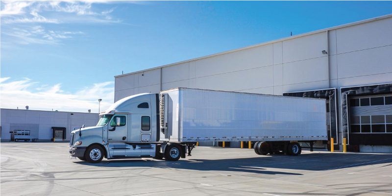 Food and beverage supplier refrigerated truck at distribution facility loading dock representing supply chain risk management